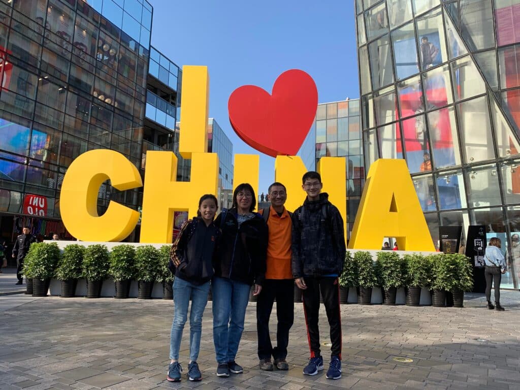 The Yuens in front of an "I (heart) China" sign