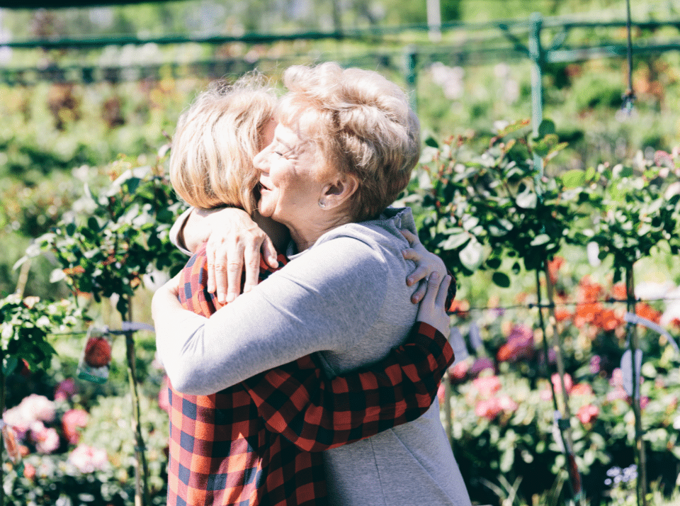 A grandmother hugging her teenage granddaughter