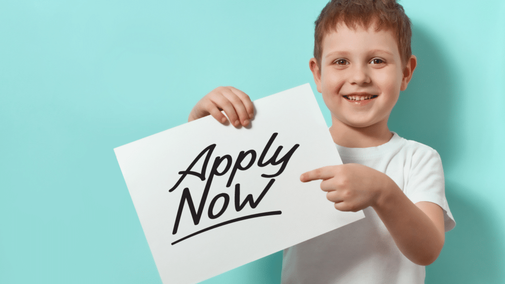 Child holding a paper and pointing to "Apply now."