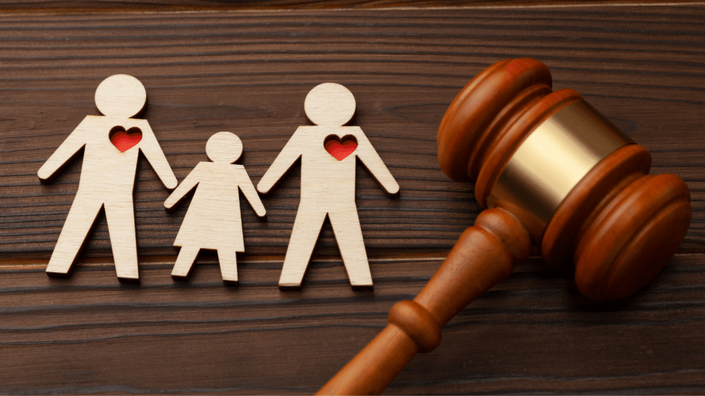 Paper cutout featuring a family of three with three hearts and a judge's gavel.