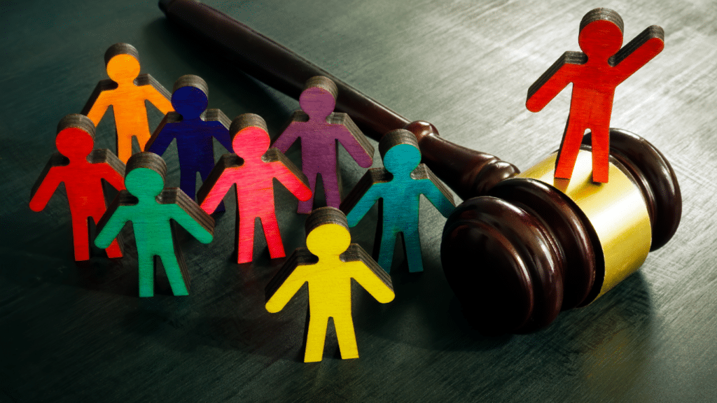 Symbolizing human rights: A gavel surrounded by colorful figurines.