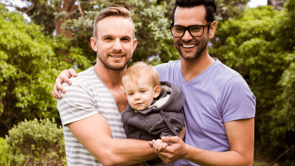 Happy gay couple with a smiling small boy.