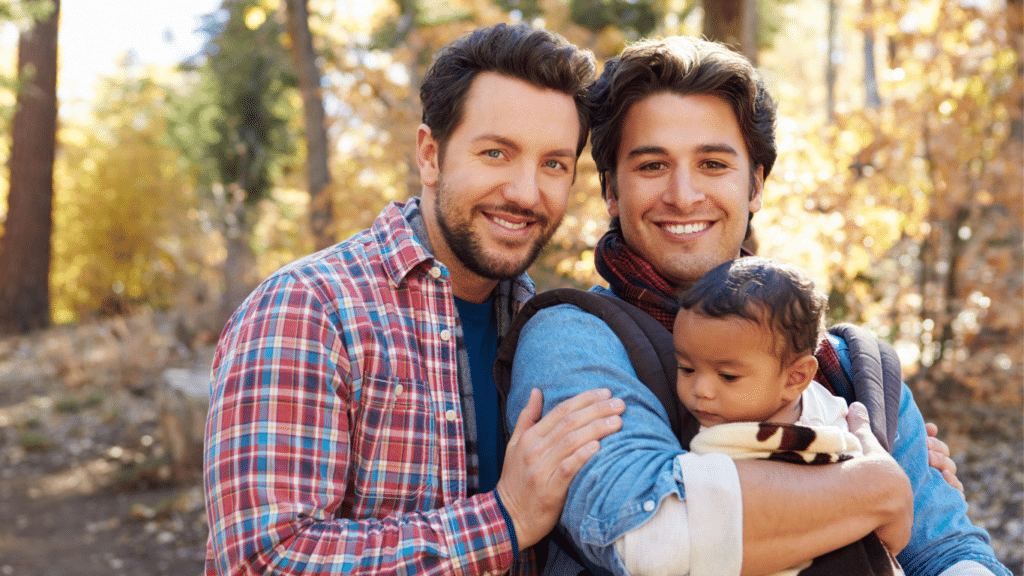Smiling gay couple with a small boy.