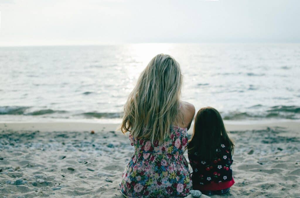 Little girl and woman at the beach