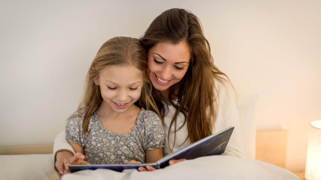 Mom and daughter reading a book.