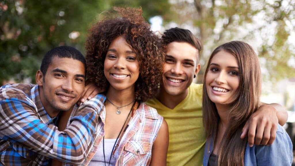 Portrait of a group of young friends standing together outdoors.