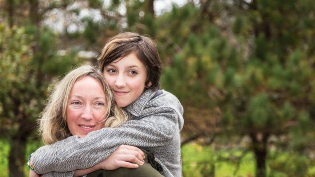 Teen daughter hugging mom