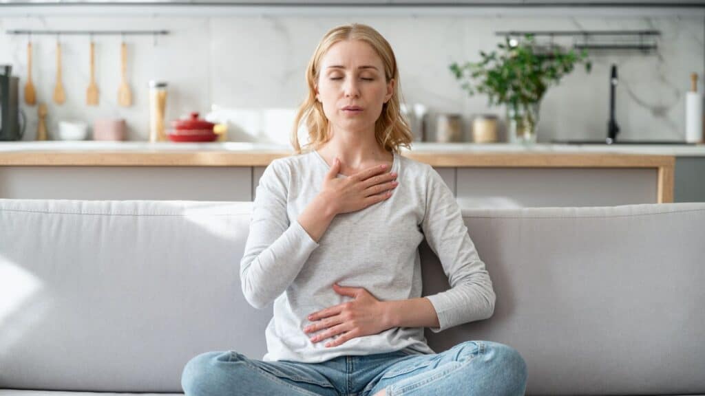 Woman doing calming breathing exercises